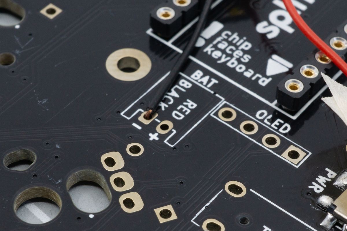 The wire is inserted from the top side of the board. If you're placing your battery differently than we recommend, it's fine to insert it from the back side too, as long black connects to - and red connects to +