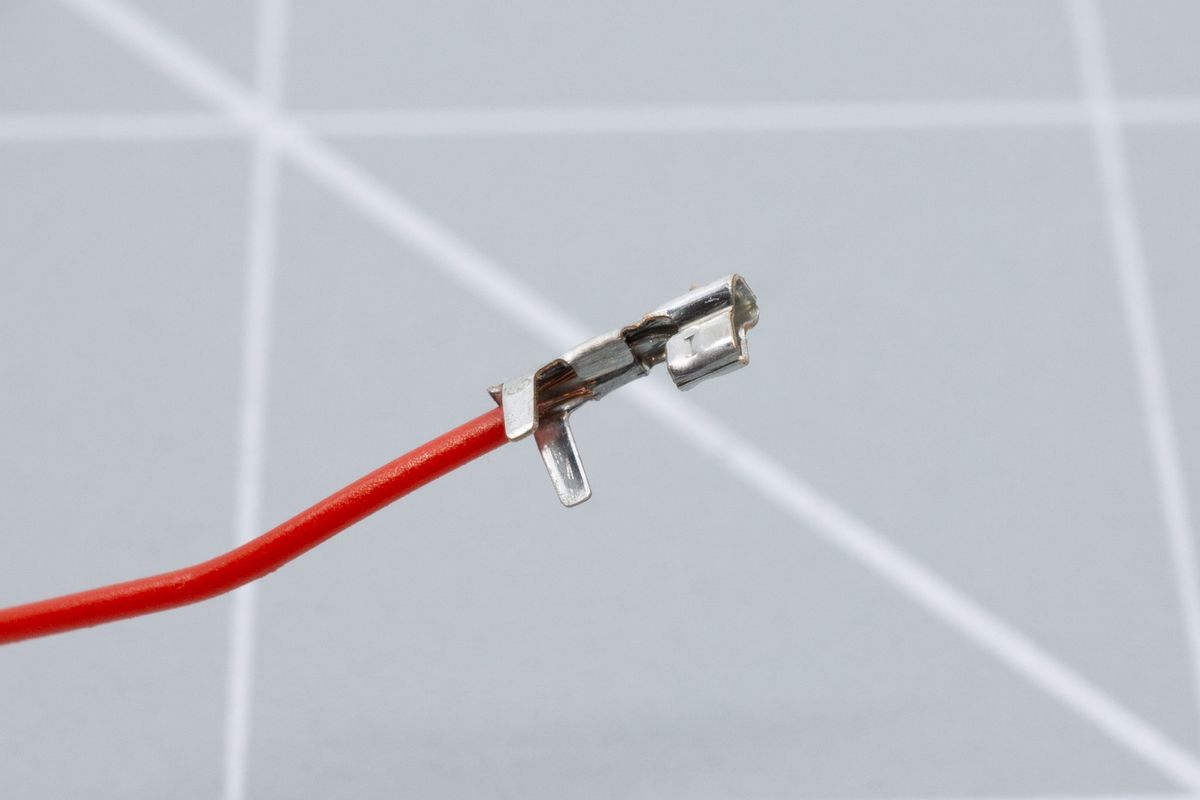 The cable, clamped in place by the first set of connector legs