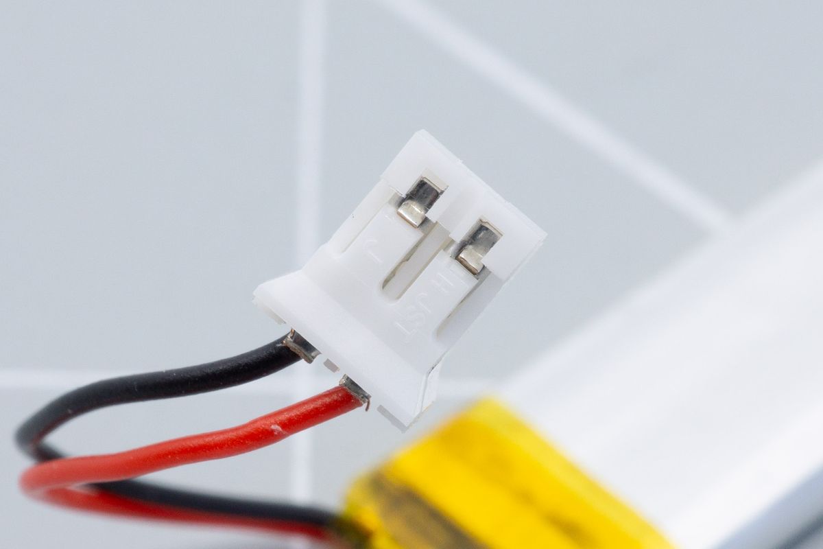 Both wires inserted into the JST plug. A little metal tab keeps the cables in place