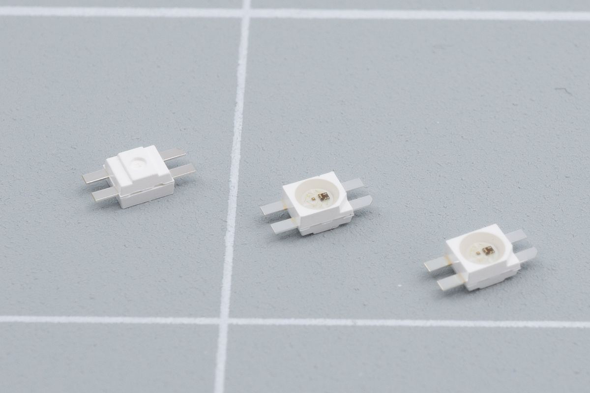 Itty bitty leggy LEDs. They have a convenient corner to mark its orientation, and the legs make them easier to solder