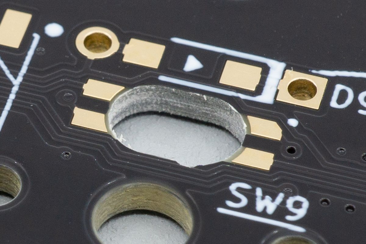 The LEDs get dropped face-down into the hole, where they then shine upward through the switches