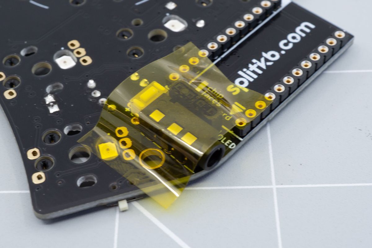 Some tape holds the 4-pin socket in place. As the socket sits lower than the TRRS jack, it's best to use tape so it won't drop out once you flip the PCB over to solder it