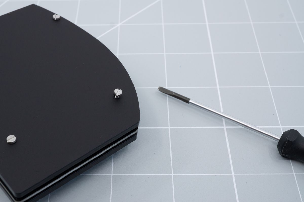 Placing a screw into one of the mounting holes