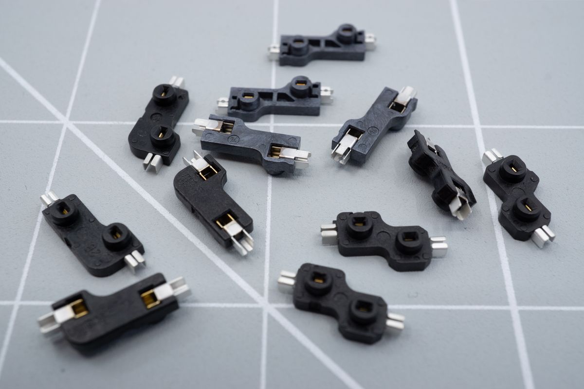 A few hotswap sockets. Those compatible with MX-switches will usually have an L-shape, while the ones for Kailh Choc low profile switches will be kind of S-shaped