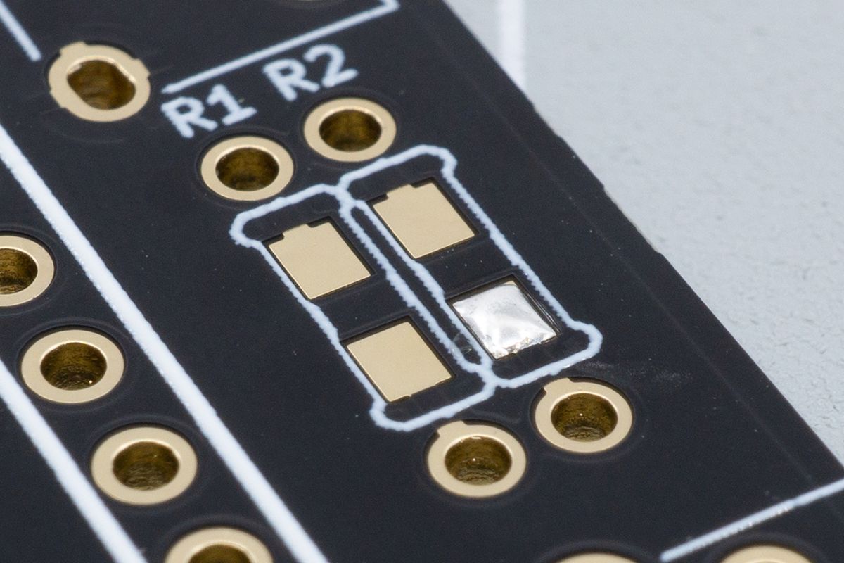 One of the resistor's SMD pads soldered, to make the next step easier