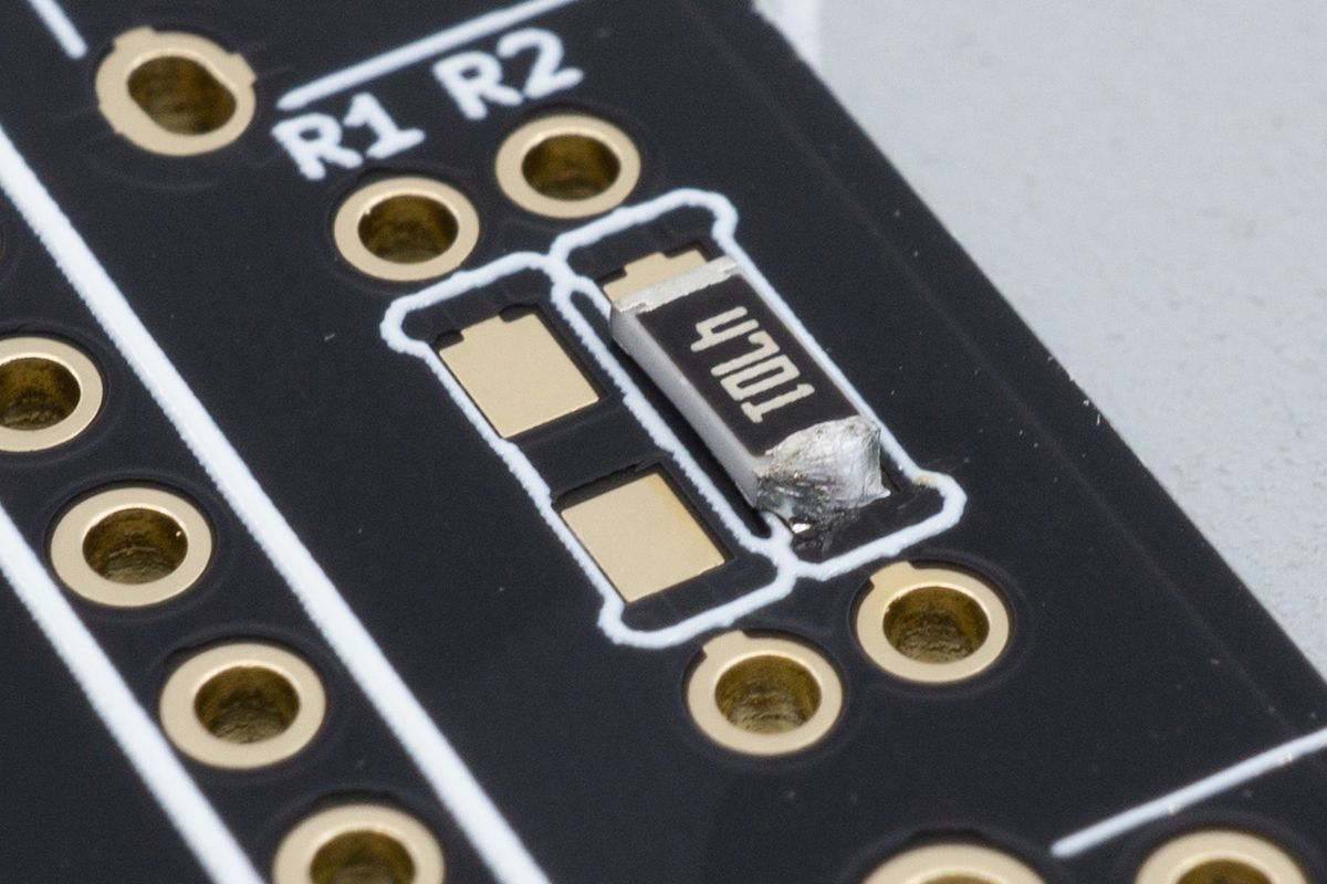 A resistor's first soldered joint. You can still adjust its position easily by reflowing this single joint