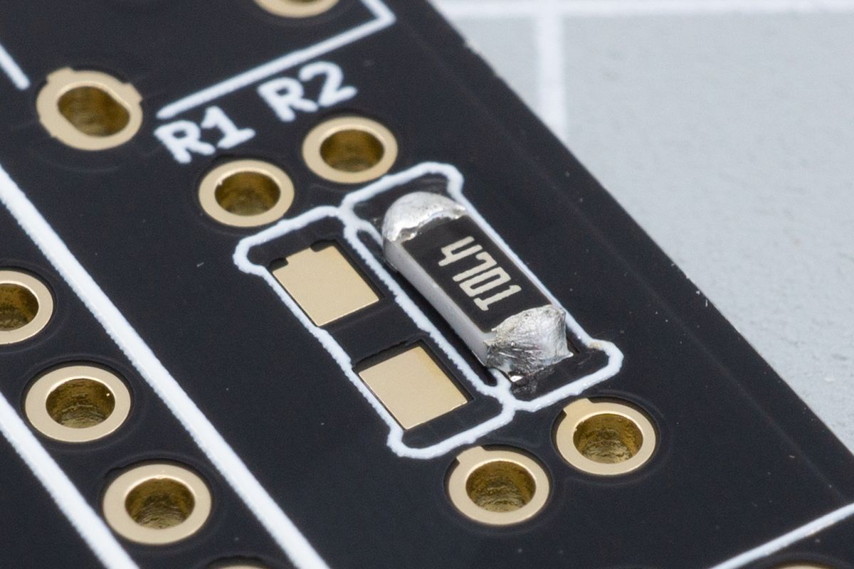 The first resistor fully soldered, with both joints looking good