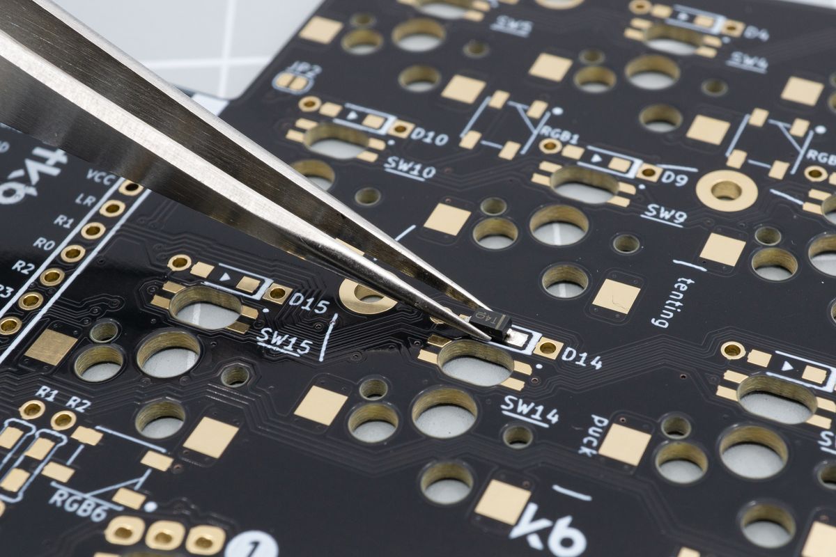 Using tweezers in one hand, move the diode in place. Using the other hand, you can then melt the solder and finalise the diode placement by nudging it around