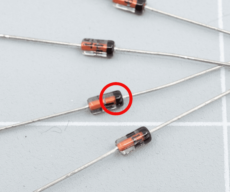 The black line on a through-hole diode hints at its intended orientation