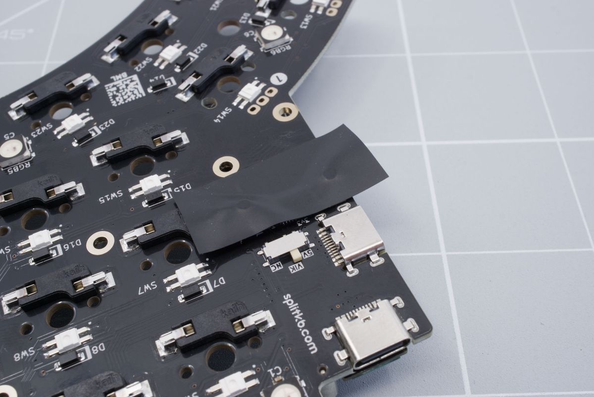 Adding tape to the bottom of the keyboard